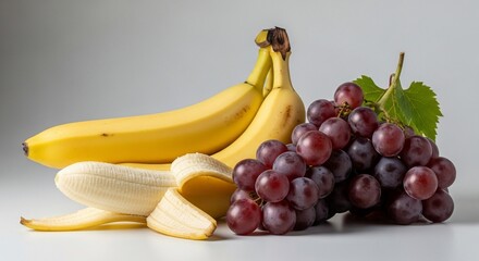 Fresh Fruit Composition: A vibrant still life featuring luscious, ripe bananas and plump grapes. captured the textures and colors. perfect for illustrating the beauty of nature's bounty.