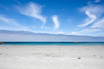 Summer day at Plage du Vougot, Guissény, Les Abers, France. Scenic Atlantic coast beach with golden sand, turquoise sea, and clear blue sky in a peaceful seaside landscape.