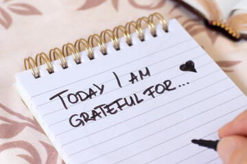 Today I am grateful for, inspirational handwritten quote in notebook. Gratitude and thanksgiving concept. Close-up.