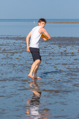 Teenage Boy Playing With A Frisbee