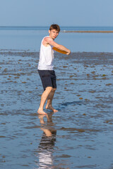 Teenage Boy Playing With A Frisbee