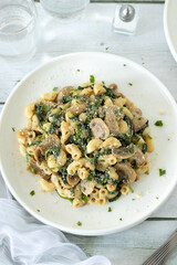 Vegan pasta dish with mushrooms and spinach. Top view.