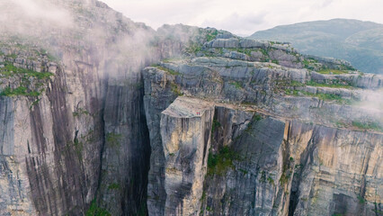 Breathtaking view from Preikestolen Cliff over the Lysefjord in Norway during early morning mist