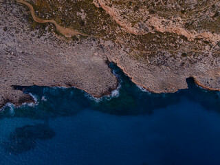 Aerial View of Rugged Cliffs and Turquoise Waters in Cyprus