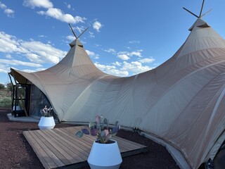 Serene Desert Camping: Resting in canvas tents under the warm sun, a peaceful outdoor adventure and escape into the wild to experience nature and solitude. © Curiosity Photos