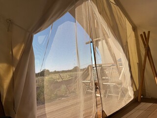 Serene Desert Camping: Resting in canvas tents under the warm sun, a peaceful outdoor adventure and escape into the wild to experience nature and solitude. © Curiosity Photos