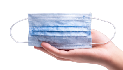 A light-blue face mask held in a hand