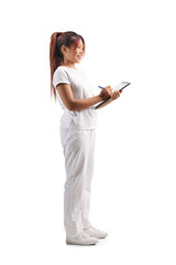 Massage therapist in a white uniform holding a clipboard