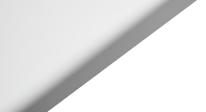 Pristine high-key studio flat lay of a brilliant white surface with a stark, sharp-edged grey diagonal shadow and soft light gradient, symbolizing new ideas