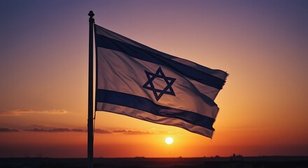 The flag of Israel proudly waving against a vibrant sunset. The flag displays a Star of David centered between two blue stripes on a white background, symbols of Jewish faith and heritage