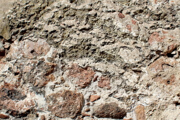 Abstract texture from a wall lined with large stones.