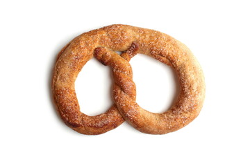 On a white background lies a bakery product called a pretzel.
