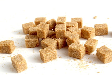A pile of brown sugar lies on a white background.