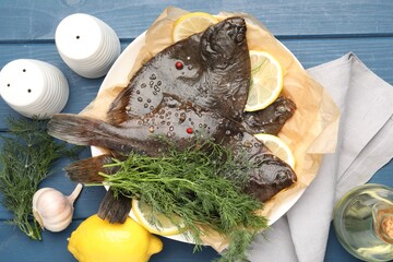 Fresh raw flounder fish and spices on blue wooden table, flat lay. Seafood