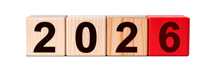 Wooden cubes showing the year 2026 on reflective surface
