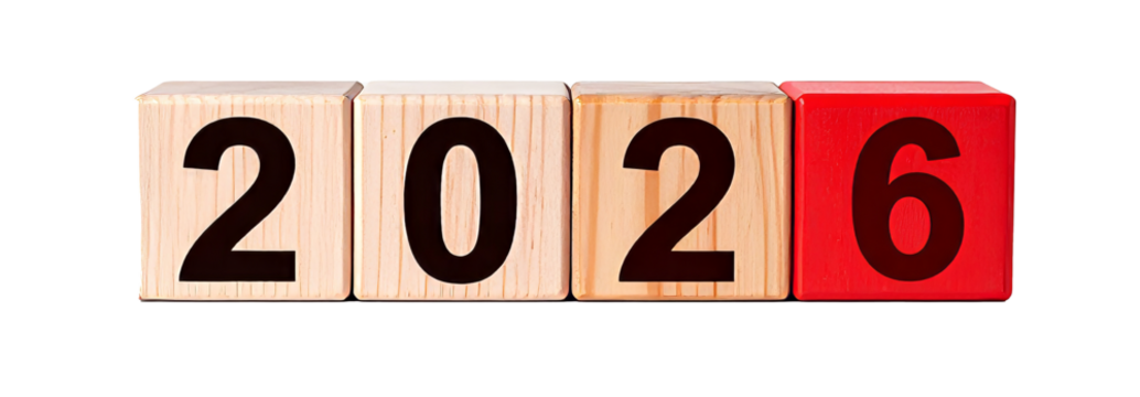 Wooden cubes showing the year 2026 on reflective surface