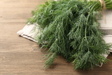 Bunch of fresh dill on wooden table, closeup