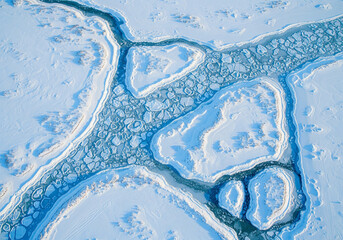 Aerial View of Broken Ice on a Frozen River: Abstract Winter Landscape