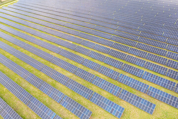 Photovoltaic farm. Photovoltaic panels in a field, view from a drone.