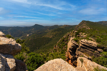 Dramatic rock formations rise above lush greenery at El Garbi, a popular lookout point in the Serra...