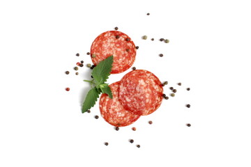 Round pieces of salami lie on a white background.