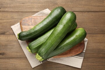 Fresh ripe zucchinis on wooden table, top view