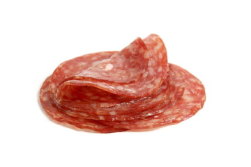 Round pieces of salami lie on a white background.