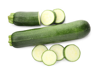Whole and cut fresh zucchinis isolated on white, top view