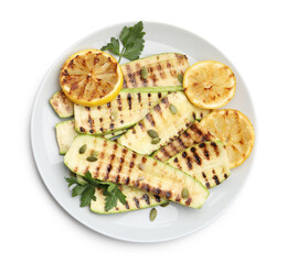 Delicious grilled courgette slices with pumpkin seeds, lemon and parsley isolated on white, top view
