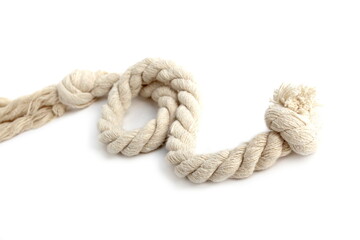 A twisting rope lies on a white background.	