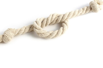 A twisting rope lies on a white background.	