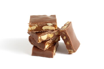 There is a stack of chocolate pieces with nuts on a white background.	