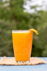 Closeup of Ripe Indian Bael Fruit Juice or Sarbat in a Glass or Wood Apple Isolated on Wooden Background with Copy Space, Also Known as Bengal Quince, Aegle Marmelos, Japanese Bitter Orange or St