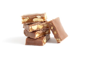There is a stack of chocolate pieces with nuts on a white background.