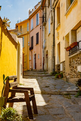 View of colourful Collioure, narrow streets and yellow, pink, orange houses, summer vacation destination town with historical buidings and beaches, Pyrenees-Orientales, France