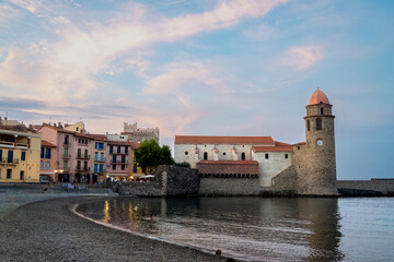 Morning view of colourful Collioure, narrow streets and yellow, pink, orange houses, summer vacation destination town with historical buidings and beaches, Pyrenees-Orientales, France