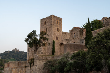 View of colourful Collioure, narrow streets and yellow, pink, orange houses, summer vacation destination town with historical buidings and beaches, Pyrenees-Orientales, France