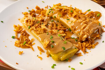 Three onions vegetarian dish, oven baked leek, dried onion and green onion served in French...