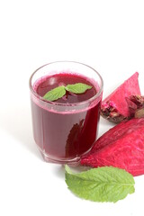 A glass of freshly squeezed beetroot juice stands on a white background.