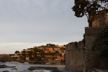 Sunset view of colourful Collioure, narrow streets and yellow, pink, orange houses, summer vacation...