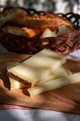 French yellow cheese Comte, varieties unpasteurised cow milk Prestige, fruity flavoured Fruite and Vieille Reserve close up on board