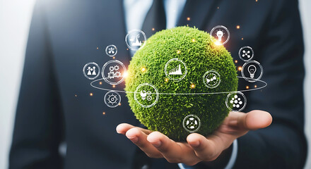 Businessperson holds a green globe with digital icons representing sustainability