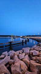 Fototapeta premium Seaside Breakwater and Lighthouse in Blue Hour