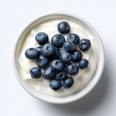 A close-up shot of fresh blueberries atop creamy yogurt in a pristine white bowl, ready to be enjoyed, representing a perfect breakfast or healthy snack.