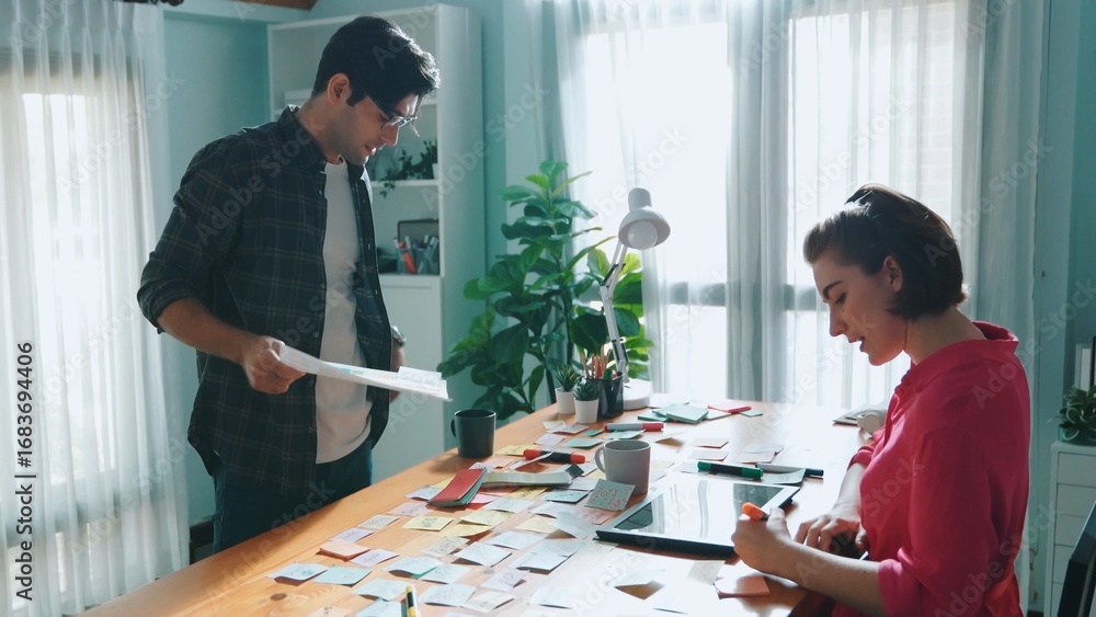 Aufkleber top view of smart designer holding color palette while project manager looking at design and choosin