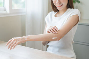 Health skin care, beauty asian young woman, girl hand applying, putting moisturizer on her arm,...