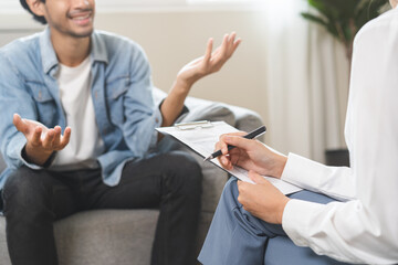 Psychology, depression. Happy smile asian young man patient mental therapy explain symptom with...