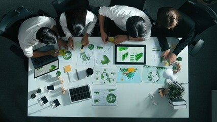 Top view of executive manager hold tablet display clean energy at meeting. Aerial view of business people working together to plan and invest in sustainable environmental investment. Alimentation.