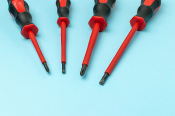 Set of Insulated Screwdrivers on Blue Background: Essential Tools for Electrical Safety