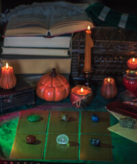 Orange candle on a vintage table, dark academia aesthetic. Evening October time